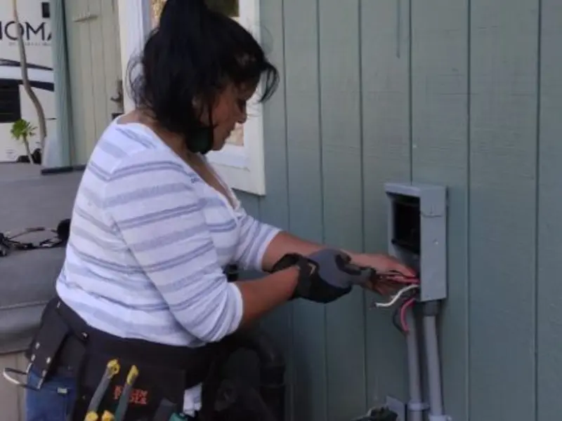 Licensed electrician wiring an exterior subpanel in Homer