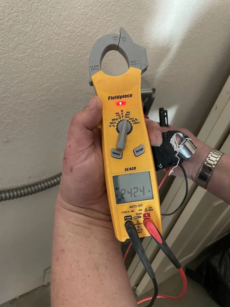 Voltage testing with clamp meter during Outlet Installation in Homer